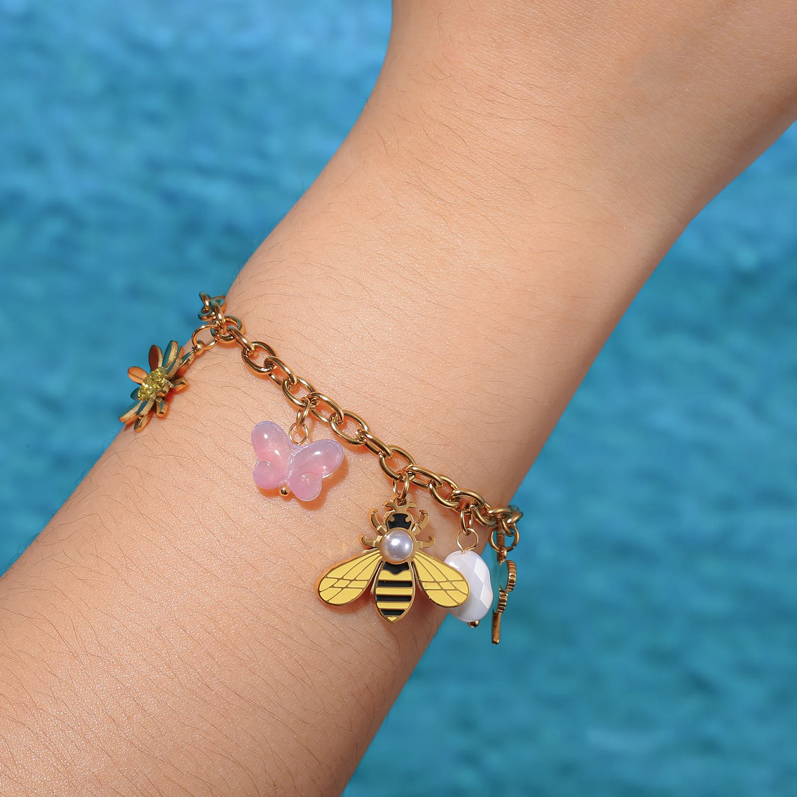 Golden Tone Stainless Steel Bee and Flower Charm Bracelet with Butterfly and Crystal Pendants for Women
Golden Tone Stainless Steel Bee and Flower Charm Bracelet with Butterfly and Crystal Pendants for Women