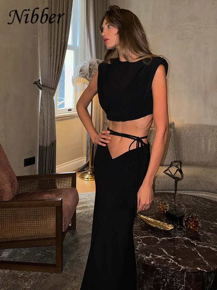 Nibber Hipster комплект из 2 предметов с высокой талией, женский сексуальный укороченный топ без рукавов с круглым вырезом + длинная юбка с полыми повязками, трендовый элегантный костюм с рюшами
Nibber Hipster комплект из 2 предметов с высокой талией, женский сексуальный укороченный топ без рукавов с круглым вырезом + длинная юбка с полыми повязками, трендовый элегантный костюм с рюшами