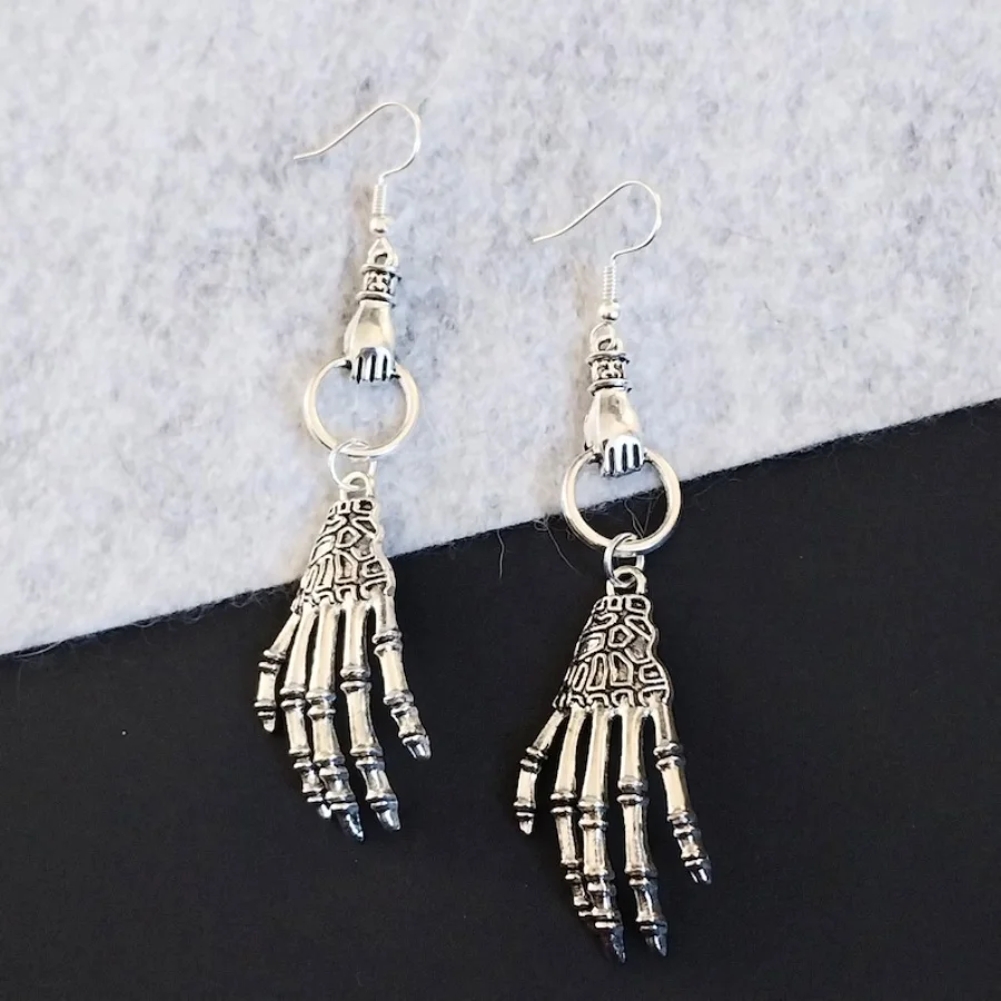 Antiqued hand holding skeleton hand dangling earrings, hypoallergenic and nickel free backs of your choice, skeleton earrings
Antiqued hand holding skeleton hand dangling earrings, hypoallergenic and nickel free backs of your choice, skeleton earrings