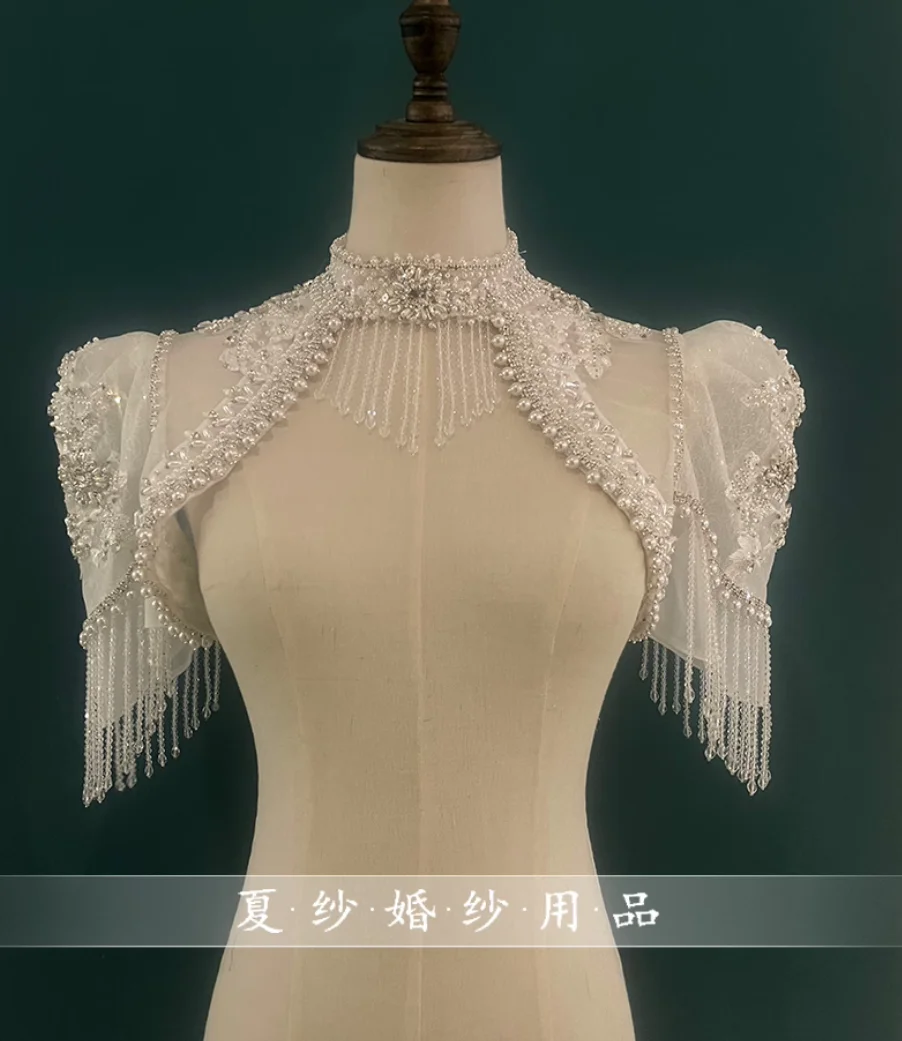 Bridal strapless wedding dress with pearl embellishments, heavy tulle shawl, tassels, off-the-shoulder design, and shoulder acce
Bridal strapless wedding dress with pearl embellishments, heavy tulle shawl, tassels, off-the-shoulder design, and shoulder acce