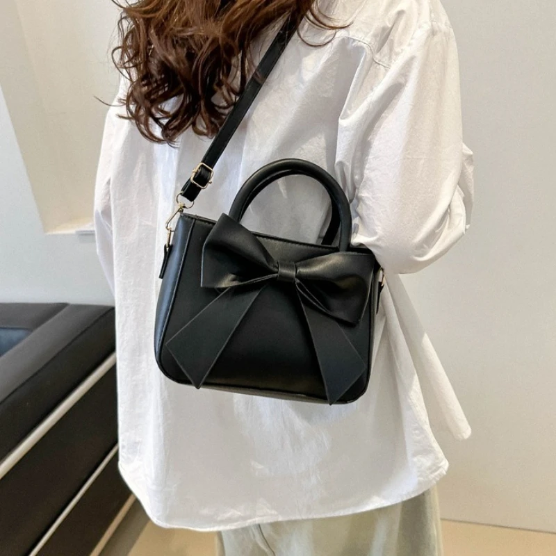 White Faux Leather Handbag with Oversized Bow Detail Top Handle Adjustable Crossbody Strap Elegant Feminine Versatile Purse
White Faux Leather Handbag with Oversized Bow Detail Top Handle Adjustable Crossbody Strap Elegant Feminine Versatile Purse