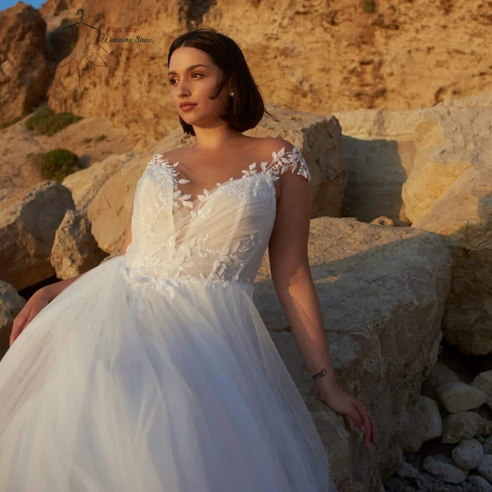 Beach A-Line Wedding Dresses Plus Size O Neck Cap Sleeves Bride Gowns Appliques Back Button Floor Length Tulle Robe De Mariee
Beach A-Line Wedding Dresses Plus Size O Neck Cap Sleeves Bride Gowns Appliques Back Button Floor Length Tulle Robe De Mariee