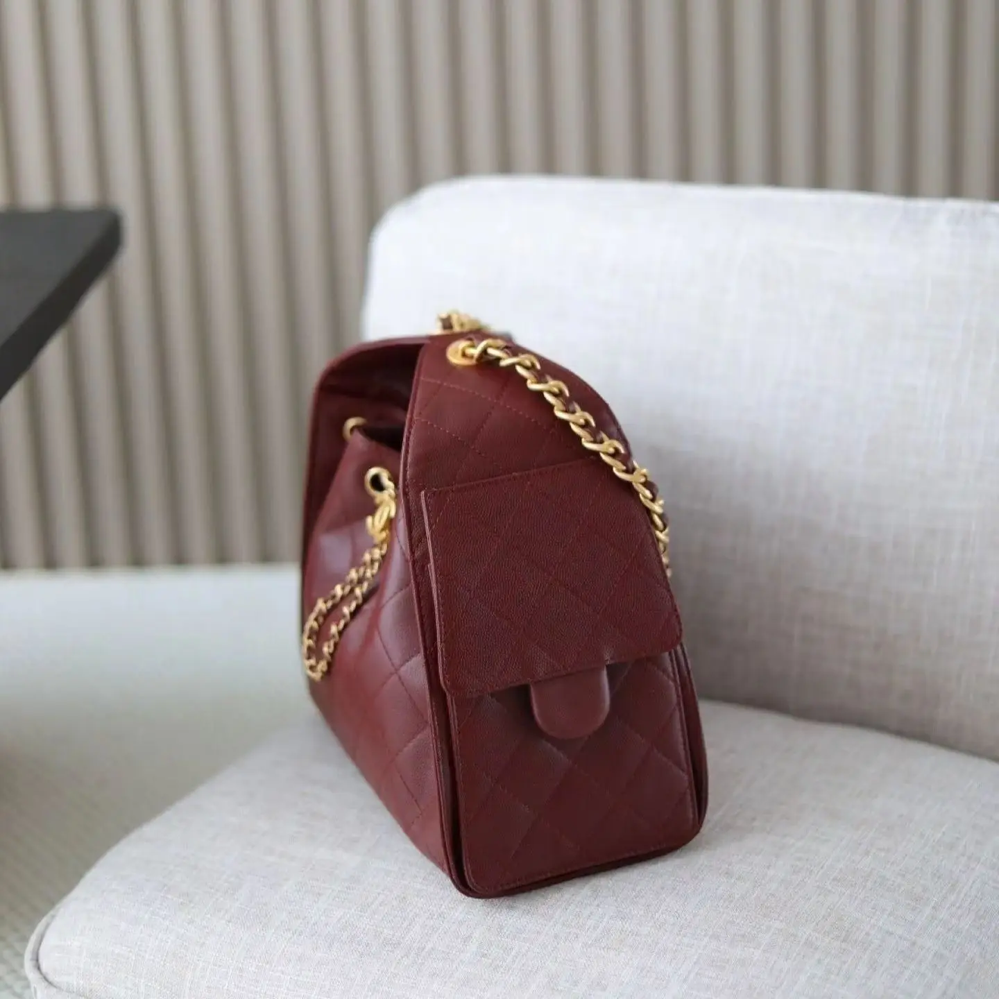 Burgundy quilted leather drawstring bag, with gold-tone hardware, chain handles and a spacious silhouette.
Burgundy quilted leather drawstring bag, with gold-tone hardware, chain handles and a spacious silhouette.