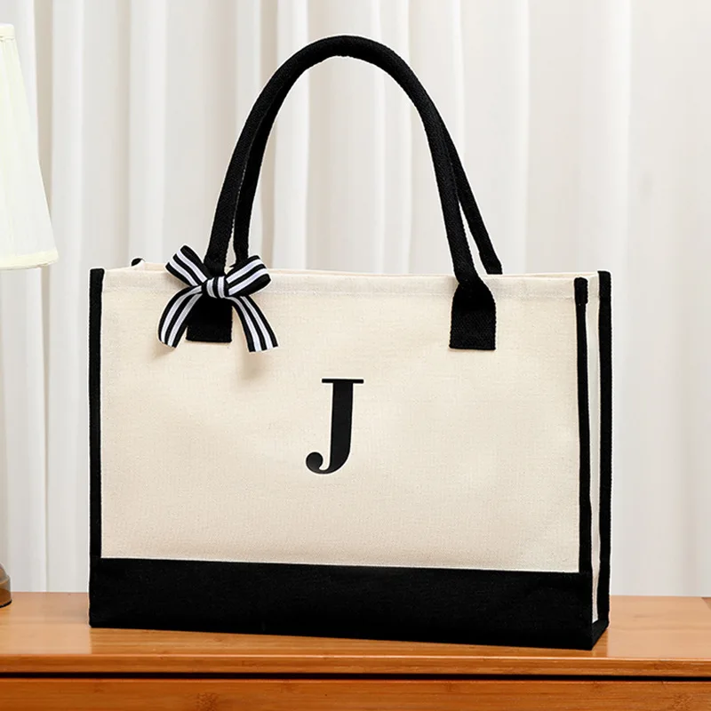 New alphabet printed men's tote bag canvas large capacity handbag lunch strap bow ribbon decoration gift shopping bag 
New alphabet printed men's tote bag canvas large capacity handbag lunch strap bow ribbon decoration gift shopping bag