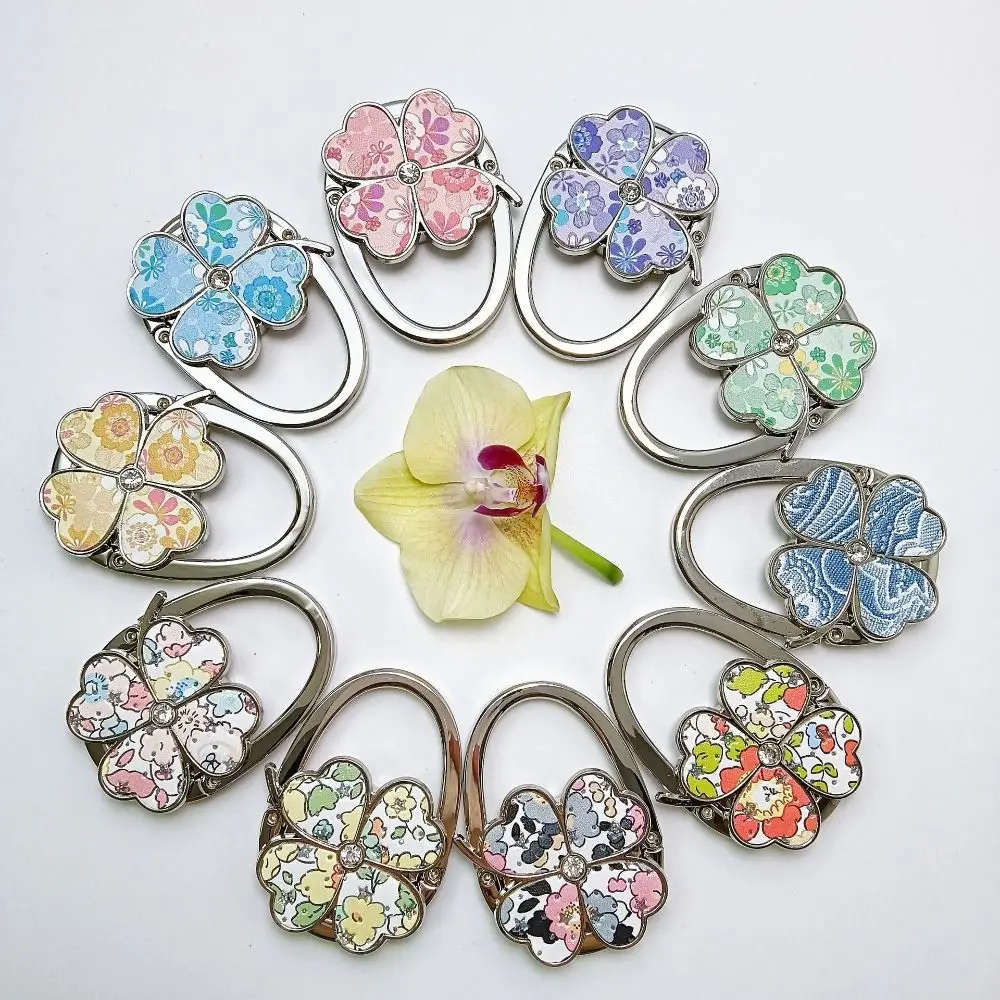 Trendy Four Leaf Clover Handbag Hook Foldable Flowers Purse Hanger Portable Purse Holder for Indoor Outdoor Table
Trendy Four Leaf Clover Handbag Hook Foldable Flowers Purse Hanger Portable Purse Holder for Indoor Outdoor Table