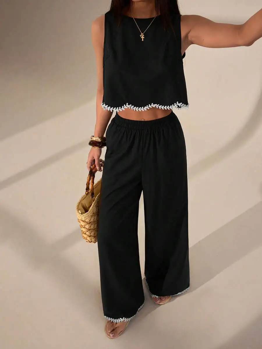 Black Sleeveless Crop Top And Wide-Leg Trousers Set With White Leaf-Embroidered Edge, Casual Summer Two-Piece Ensemble
Black Sleeveless Crop Top And Wide-Leg Trousers Set With White Leaf-Embroidered Edge, Casual Summer Two-Piece Ensemble
