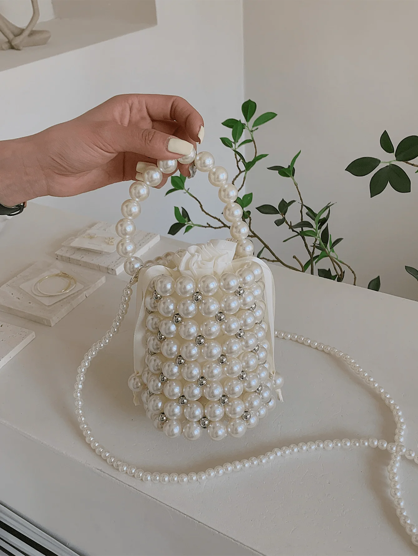 Mini Pearl-Embellished Drawstring Bucket Bag with Rhinestone Accents
Mini Pearl-Embellished Drawstring Bucket Bag with Rhinestone Accents
