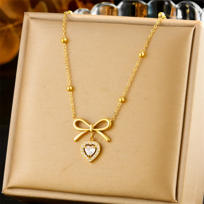 18K Gold Plated Bow & Heart CZ Necklace, Delicate Beaded Chain with Dangling Charm, Stainless Steel Romantic Statement Jewelry
18K Gold Plated Bow & Heart CZ Necklace, Delicate Beaded Chain with Dangling Charm, Stainless Steel Romantic Statement Jewelry