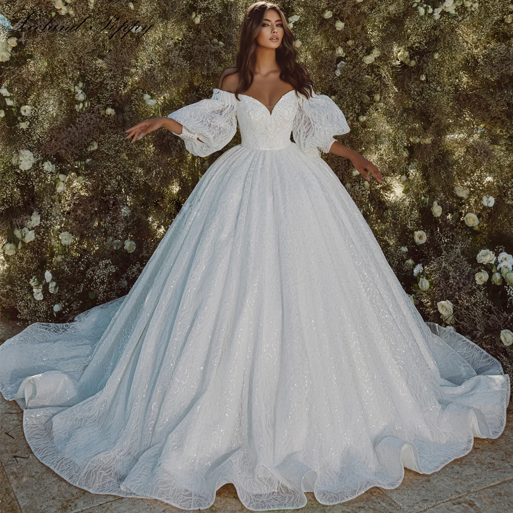 Lceland Poppy Boat Neck Ball Gown Lace Wedding Dresses 2023 Floor Length Beaded Puff Sleeves Bridal Gowns with Cathedral Train
Lceland Poppy Boat Neck Ball Gown Lace Wedding Dresses 2023 Floor Length Beaded Puff Sleeves Bridal Gowns with Cathedral Train