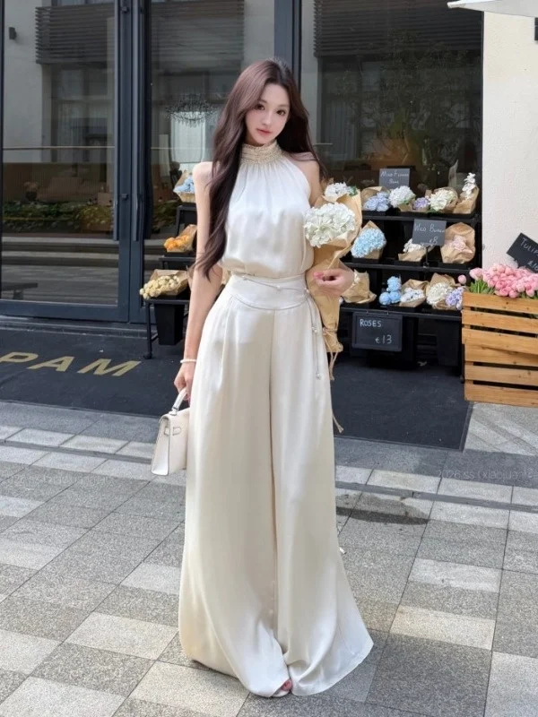 Elegant Satin Sleeveless Top High Waist Wide Leg Pants Two Piece Set Fashionable Slimming Summer Outfit Chic Neck Hanging Design
Elegant Satin Sleeveless Top High Waist Wide Leg Pants Two Piece Set Fashionable Slimming Summer Outfit Chic Neck Hanging Design