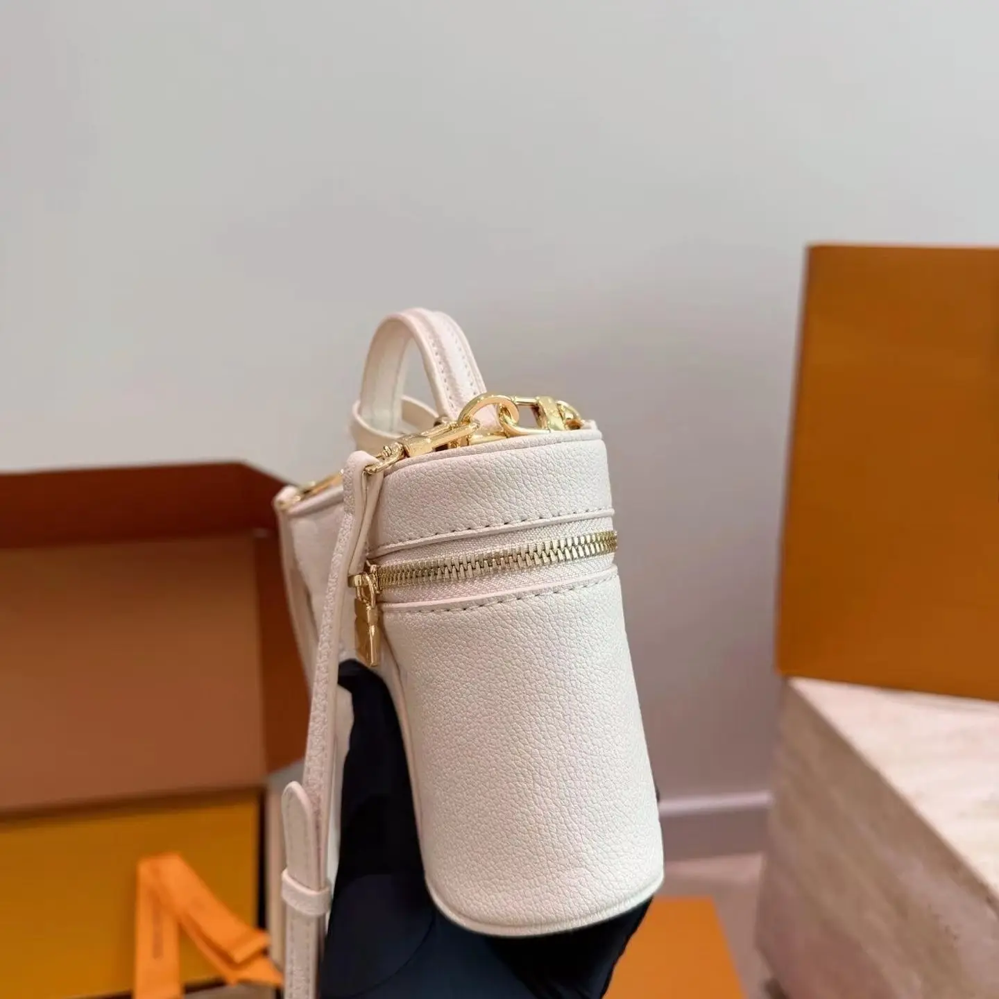 Cream Pebbled Leather Mini Vanity Case Bag, Horizontal Full-Zip Opening, Front Oversized Gold Padlock Hardware, Small Curved Matching Leather Top Handle.
Cream Pebbled Leather Mini Vanity Case Bag, Horizontal Full-Zip Opening, Front Oversized Gold Padlock Hardware, Small Curved Matching Leather Top Handle.