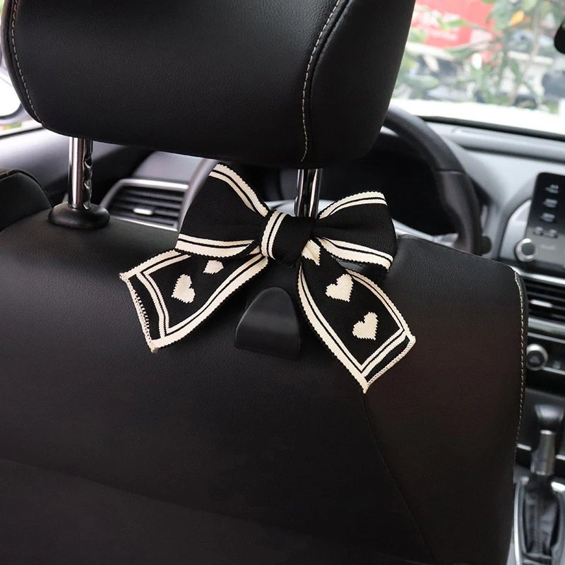 Two Car Seat Headrest Hooks Featuring A Black-and-white Heart-shaped Bow Design; A Universal Design Suitable For All Vehicles.
Two Car Seat Headrest Hooks Featuring A Black-and-white Heart-shaped Bow Design; A Universal Design Suitable For All Vehicles.