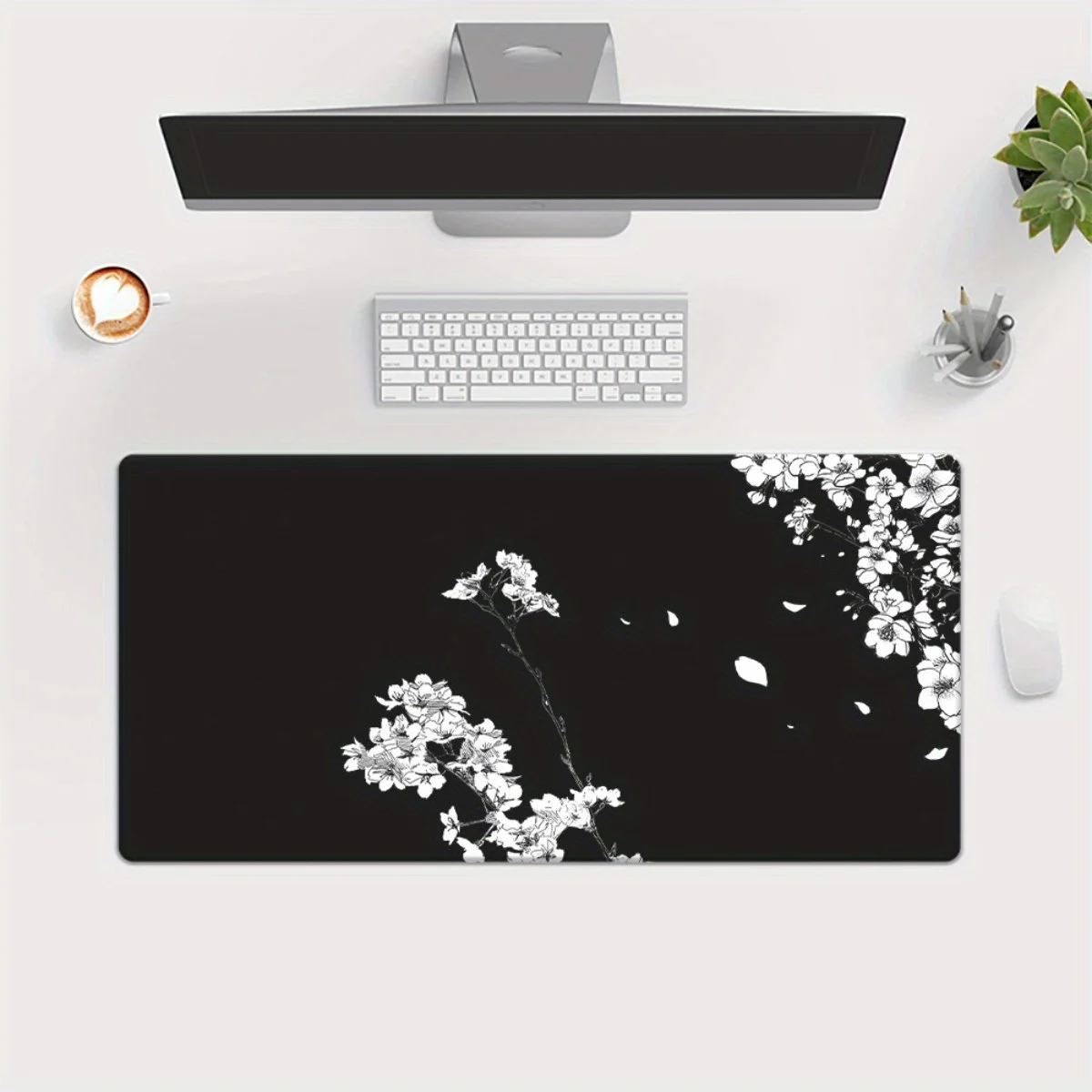 A Large Desk Pad Featuring a White Floral Design on a Black Backdrop, Perfect for Gaming Mice And Keyboards.
A Large Desk Pad Featuring a White Floral Design on a Black Backdrop, Perfect for Gaming Mice And Keyboards.