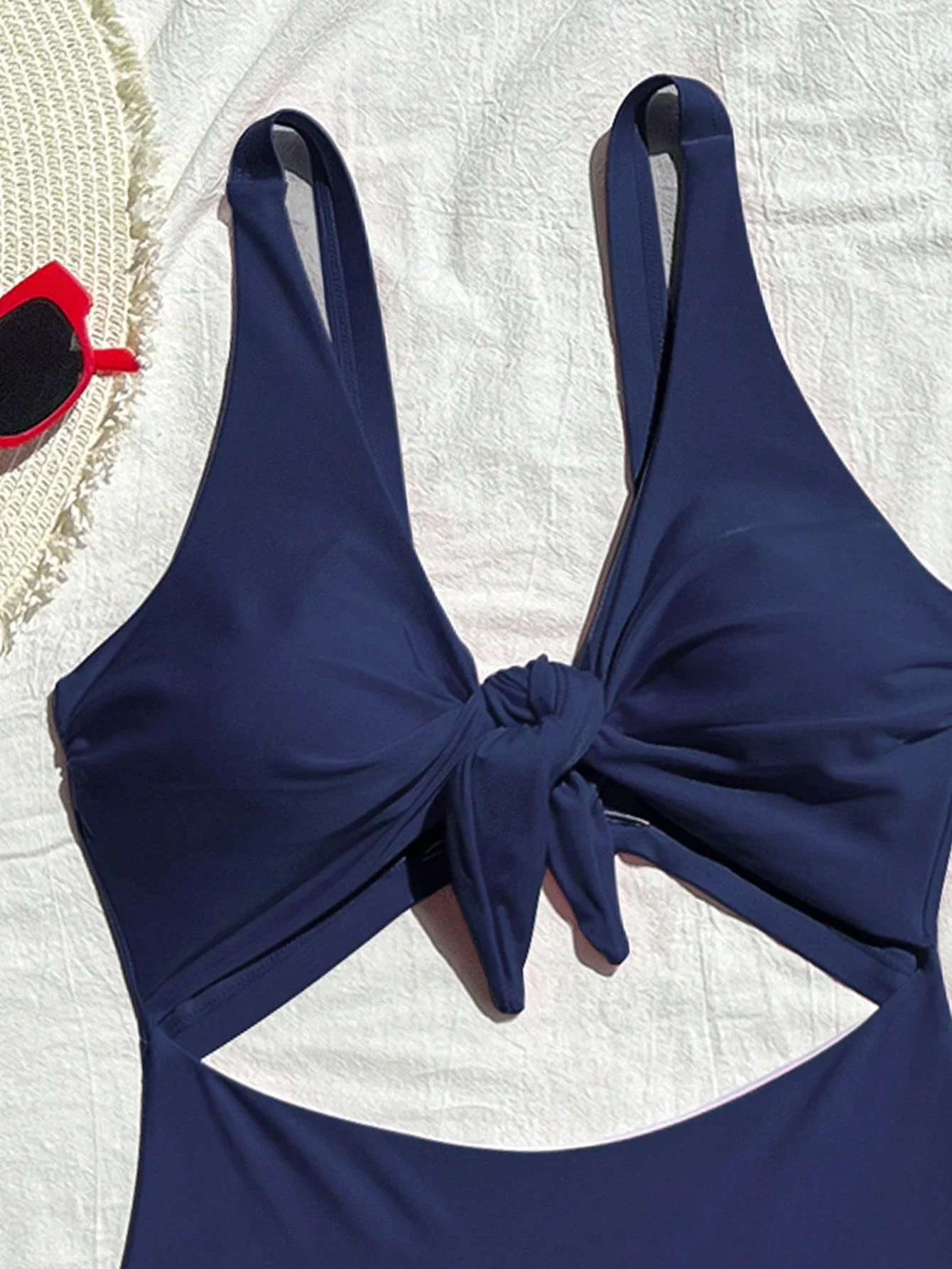 Navy Blue Solid One Piece Swimsuit With Cut Out And Front Knot
Navy Blue Solid One Piece Swimsuit With Cut Out And Front Knot