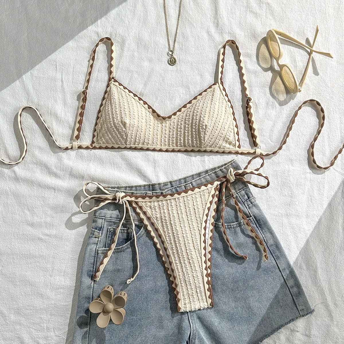 Beige Bikini Triangle Top Thong Bottom Tie Side Two Piece Swimsuit Ruched Texture Adjustable Straps Crochet Knit Brown Trim
Beige Bikini Triangle Top Thong Bottom Tie Side Two Piece Swimsuit Ruched Texture Adjustable Straps Crochet Knit Brown Trim