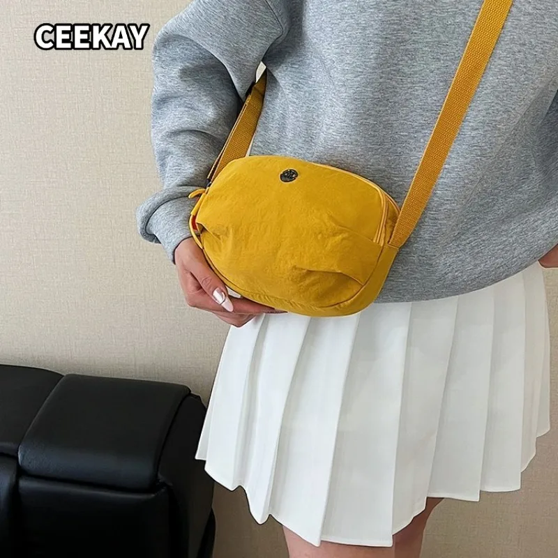 CEEKAY Matte Black Crinkle Nylon Slim Oval Sling Bag Simple Front Metal Ornament Wide Adjustable Fabric Strap Casual Unisex Bag
CEEKAY Matte Black Crinkle Nylon Slim Oval Sling Bag Simple Front Metal Ornament Wide Adjustable Fabric Strap Casual Unisex Bag