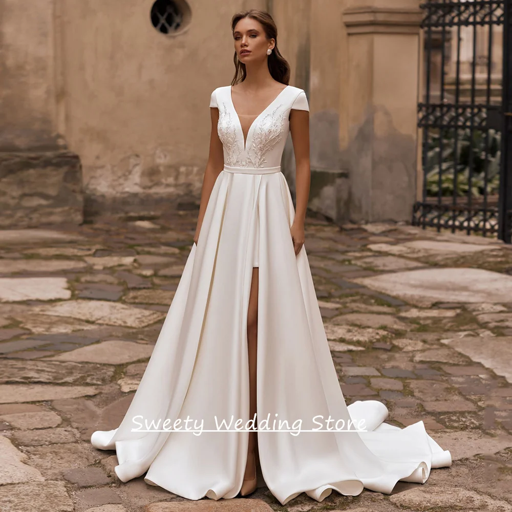 2026 Wedding Dress for Bride Customized Cap Sleeve Deep V Neck Beading Applique High Split Sweep Train Satin Bridal Gown
2026 Wedding Dress for Bride Customized Cap Sleeve Deep V Neck Beading Applique High Split Sweep Train Satin Bridal Gown