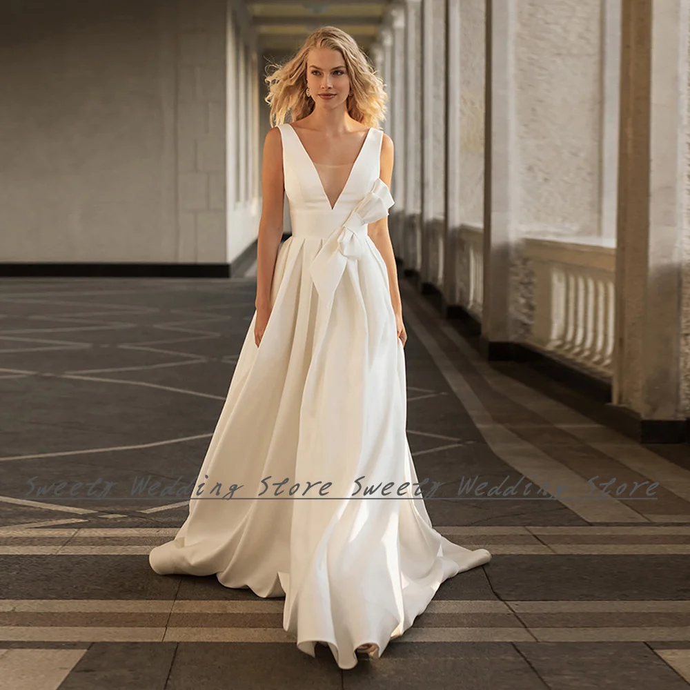 Modern Ivory Satin Wedding Dresses New Arrival Deep V Neck Sleeveless Big Bow A Line Open Back Vestido De Noiva Bridal Gown
Modern Ivory Satin Wedding Dresses New Arrival Deep V Neck Sleeveless Big Bow A Line Open Back Vestido De Noiva Bridal Gown