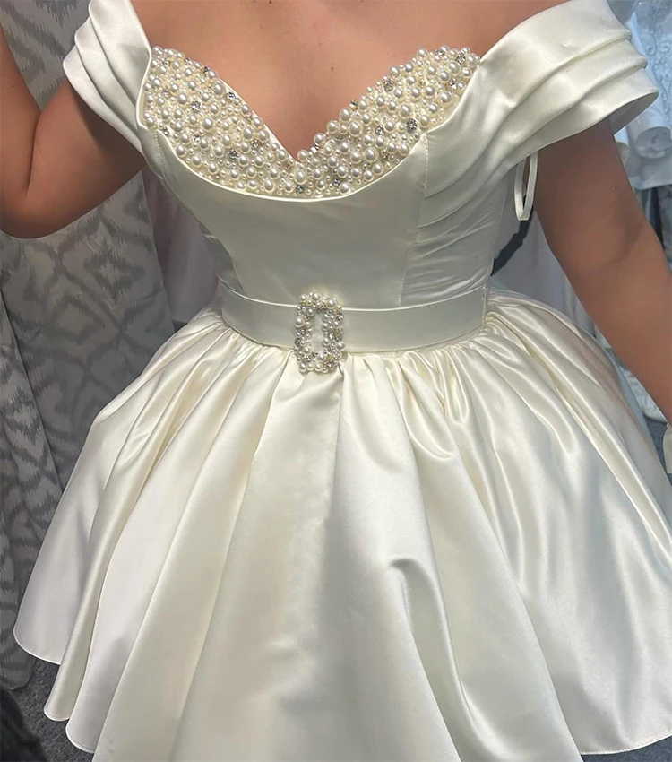 Short Wedding Dress Off the Shoulder Pearl Sweetheart Belt Ball Gown Wedding Gowns for Women 2026 Bride Ruched Satin Bridal Gown
Short Wedding Dress Off the Shoulder Pearl Sweetheart Belt Ball Gown Wedding Gowns for Women 2026 Bride Ruched Satin Bridal Gown
