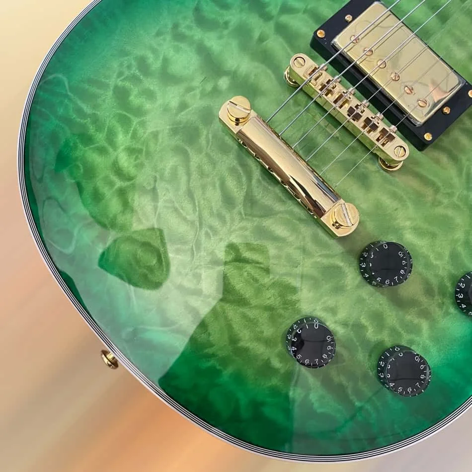 Green Flame Maple-Veneered Electric Guitar, Gold Hardware, 2 Pickups, Rosewood Fingerboard
Green Flame Maple-Veneered Electric Guitar, Gold Hardware, 2 Pickups, Rosewood Fingerboard