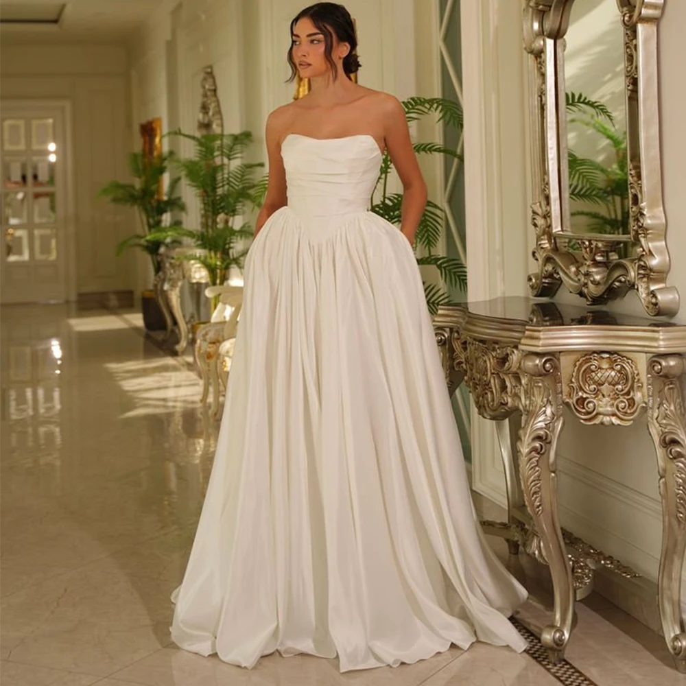 Minimalist A-Line Taffeta Wedding Dress with Pockets for Women Customized Strapless Sleeveless Zipepr Back Bridal Gowns 2026
Minimalist A-Line Taffeta Wedding Dress with Pockets for Women Customized Strapless Sleeveless Zipepr Back Bridal Gowns 2026