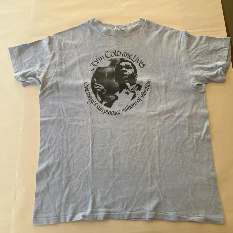 Vintage Late 1970s John Coltrane Lives T Shirt 100 Cotton Large
Vintage Late 1970s John Coltrane Lives T Shirt 100 Cotton Large