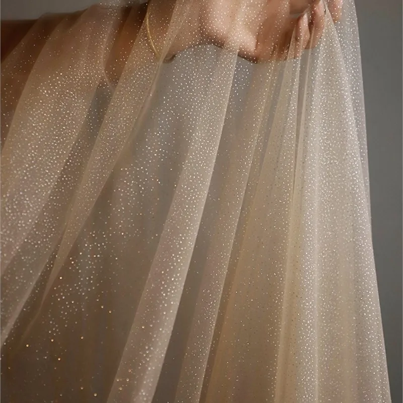 Champagne-colored white silver-coated soft mesh fabric veil wedding dress and evening gown photography background
Champagne-colored white silver-coated soft mesh fabric veil wedding dress and evening gown photography background