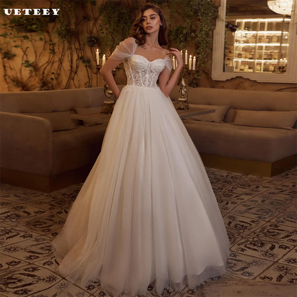 UETEEY Customized Princess Off Shoulder Lace Shiny Tulle Wedding Dress V Neck A Line Lace Up Back Court Train vestidos de novia
UETEEY Customized Princess Off Shoulder Lace Shiny Tulle Wedding Dress V Neck A Line Lace Up Back Court Train vestidos de novia