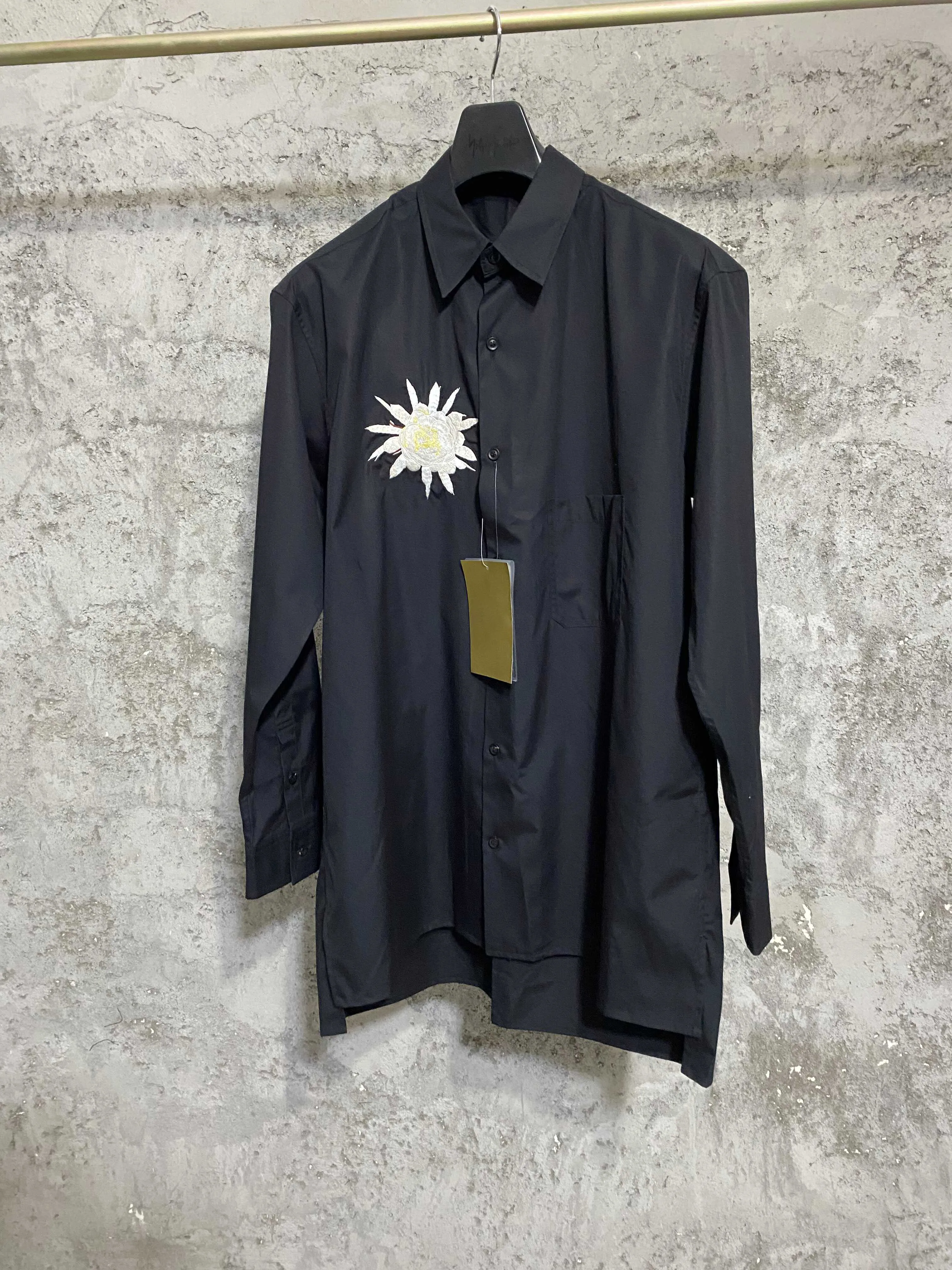 A Japanese-style original design, dark and loose rayon shirt with red flower embroidery on the chest
A Japanese-style original design, dark and loose rayon shirt with red flower embroidery on the chest