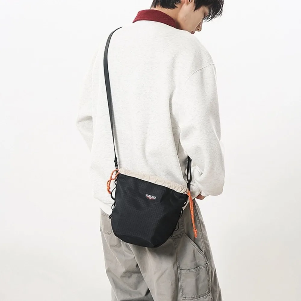 Nylon Drawstring Bucket Bag Large Capacity Lightweight Sports Crossbody Bag Phone Bag Adjustable Strap Canvas Shoulder Bag
Nylon Drawstring Bucket Bag Large Capacity Lightweight Sports Crossbody Bag Phone Bag Adjustable Strap Canvas Shoulder Bag