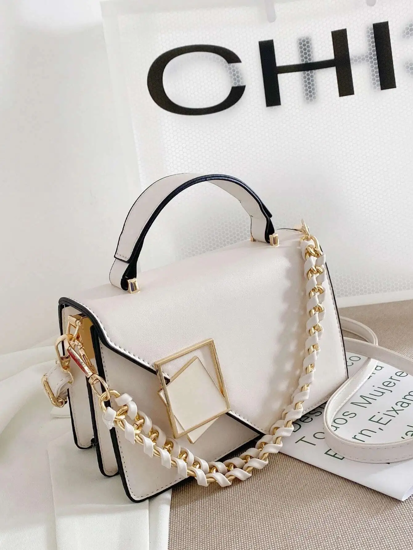 White Square Top-Handle Crossbody Bag with Gold Chain Strap and Flap Closure
White Square Top-Handle Crossbody Bag with Gold Chain Strap and Flap Closure