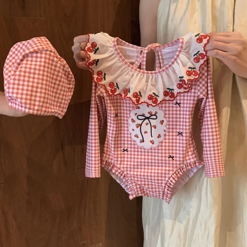 2026 New Summer Girls' Cherry Printed Sunscreen Long Sleeved Plaid Cute Embroidered Lace up Swimsuit and Swim Cap
2026 New Summer Girls' Cherry Printed Sunscreen Long Sleeved Plaid Cute Embroidered Lace up Swimsuit and Swim Cap