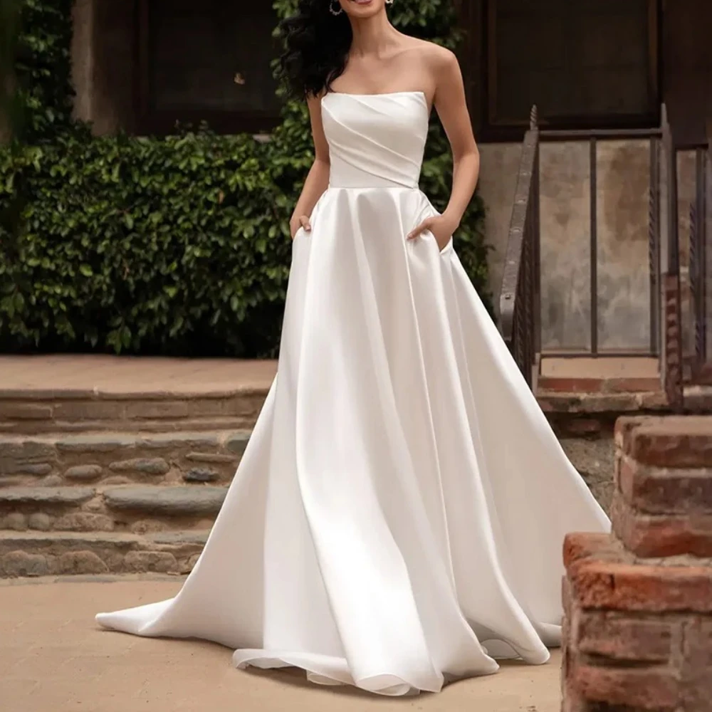 Простое свадебное платье на заказ без бретелек со складками из атласа, элегантное длинное свадебное платье трапециевидной формы с открытой спиной, 2025 Vestidos De Novias
Простое свадебное платье на заказ без бретелек со складками из атласа, элегантное длинное свадебное платье трапециевидной формы с открытой спиной, 2025 Vestidos De Novias