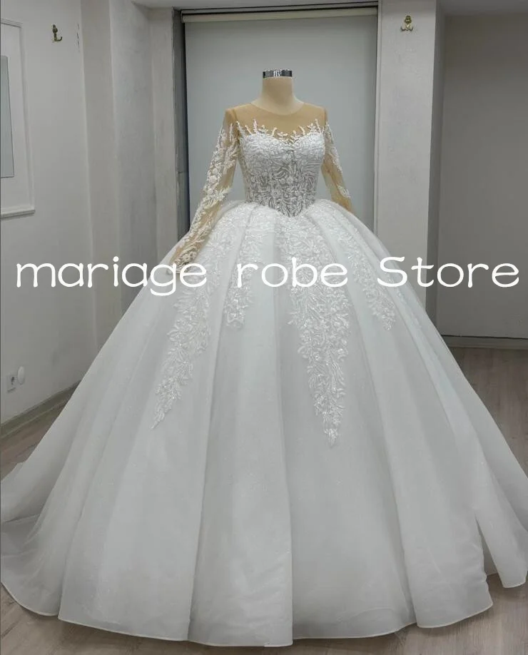 Luxury Sparkly Ball Gown Wedding Dresses Illusion Long Sleeve Shiny Applique Floral Customsized Saudi Garden Bride Gown
Luxury Sparkly Ball Gown Wedding Dresses Illusion Long Sleeve Shiny Applique Floral Customsized Saudi Garden Bride Gown