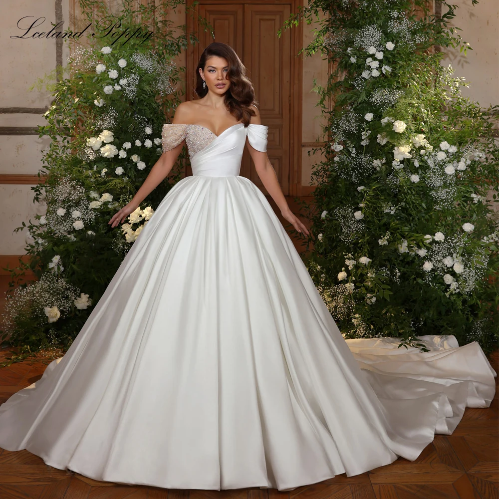 Lceland Poppy Customized A Line Off the Shoulder Satin Wedding Dress Beaded Floor Length Pleated Bridal Gowns with Chapel Train
Lceland Poppy Customized A Line Off the Shoulder Satin Wedding Dress Beaded Floor Length Pleated Bridal Gowns with Chapel Train