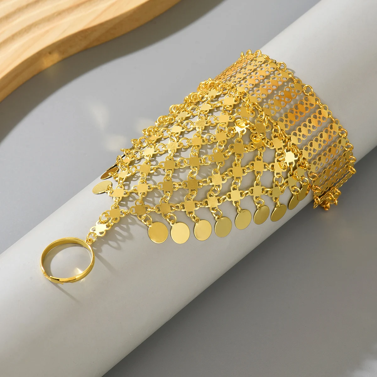 A Retro Ethnic Style Metal-Gilded Hollow-Carved Round Pendant Tassel Personalized Design Finger Chain
A Retro Ethnic Style Metal-Gilded Hollow-Carved Round Pendant Tassel Personalized Design Finger Chain
