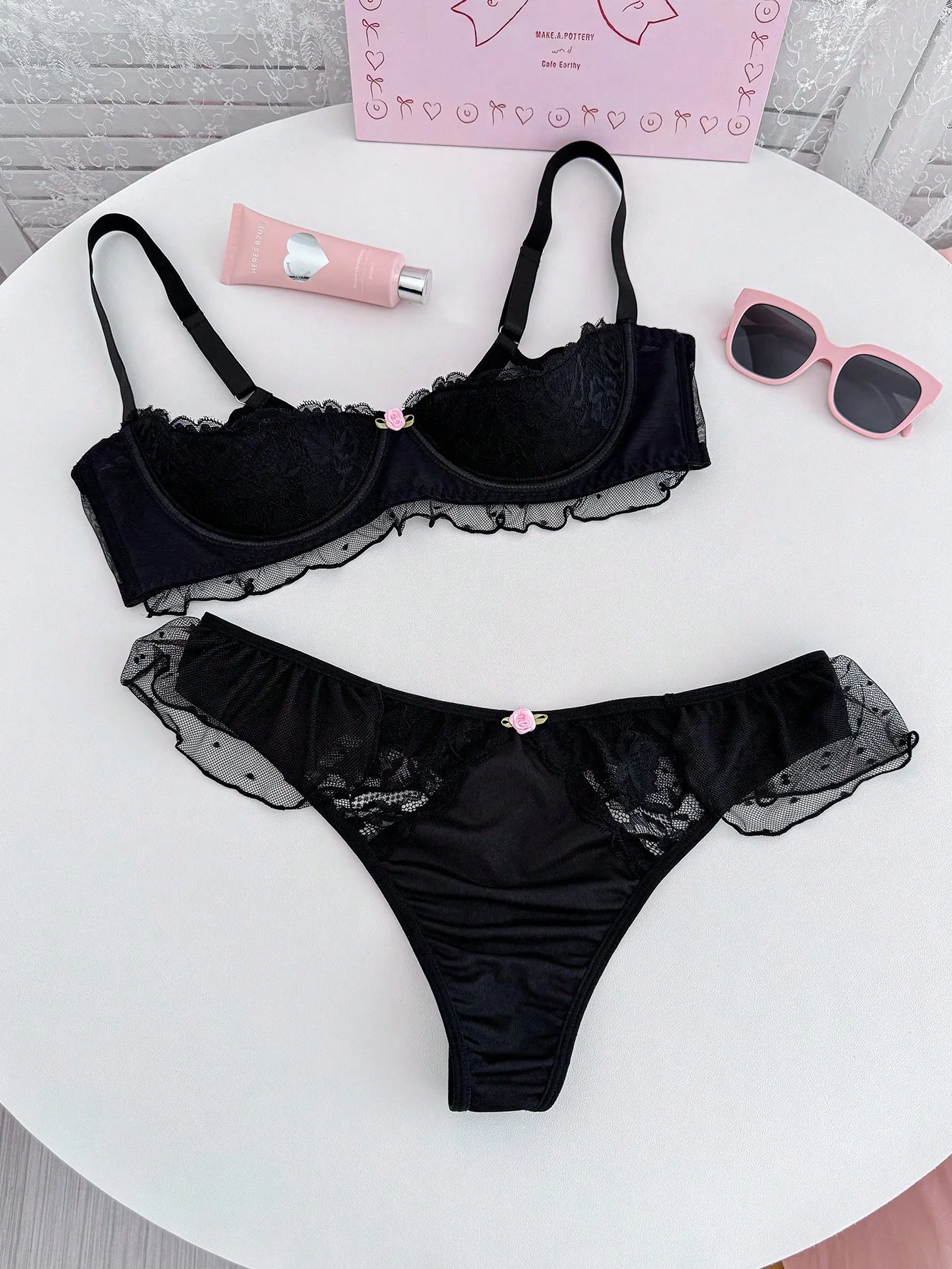 Black Lace Trimmed Bra and Panty Set with Floral Embellishment
Black Lace Trimmed Bra and Panty Set with Floral Embellishment