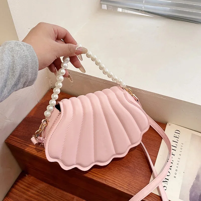 Прочная милая сумка через плечо в виде ракушки, минималистичный дизайн с жемчугом, сумка через плечо из искусственной кожи, украшенная жемчугом, сумка для женщин и девочек
Прочная милая сумка через плечо в виде ракушки, минималистичный дизайн с жемчугом, сумка через плечо из искусственной кожи, украшенная жемчугом, сумка для женщин и девочек