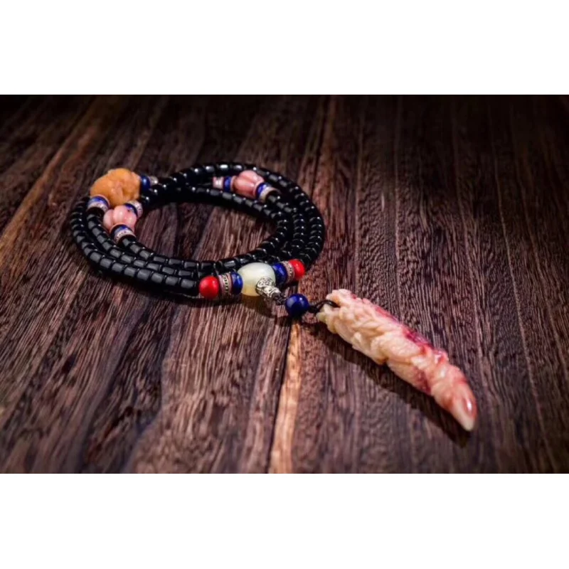 Pure black opaque horn bracelet paired with weathered Bodhi root carving of a lion holding a ball + dragon tip pendant
Pure black opaque horn bracelet paired with weathered Bodhi root carving of a lion holding a ball + dragon tip pendant