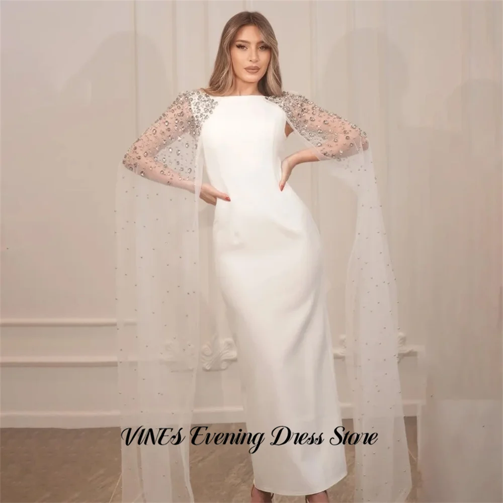 Белое вечернее платье VINES с кристаллами, выпускное платье с круглым вырезом, платье для знаменитостей, с прозрачными рукавами-накидкой, на заказ
Белое вечернее платье VINES с кристаллами, выпускное платье с круглым вырезом, платье для знаменитостей, с прозрачными рукавами-накидкой, на заказ