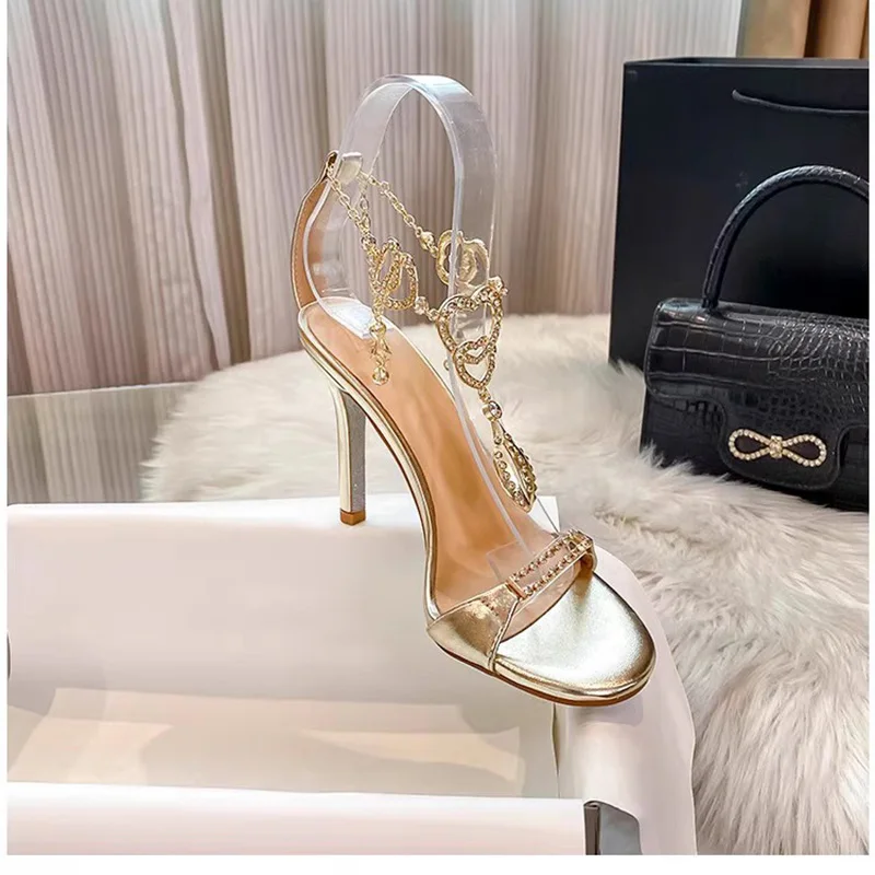 Новинка 2023 года, женские элегантные босоножки на тонком каблуке с золотым кулоном и стразами, летние босоножки на тонком каблуке с открытым носком
Новинка 2023 года, женские элегантные босоножки на тонком каблуке с золотым кулоном и стразами, летние босоножки на тонком каблуке с открытым носком