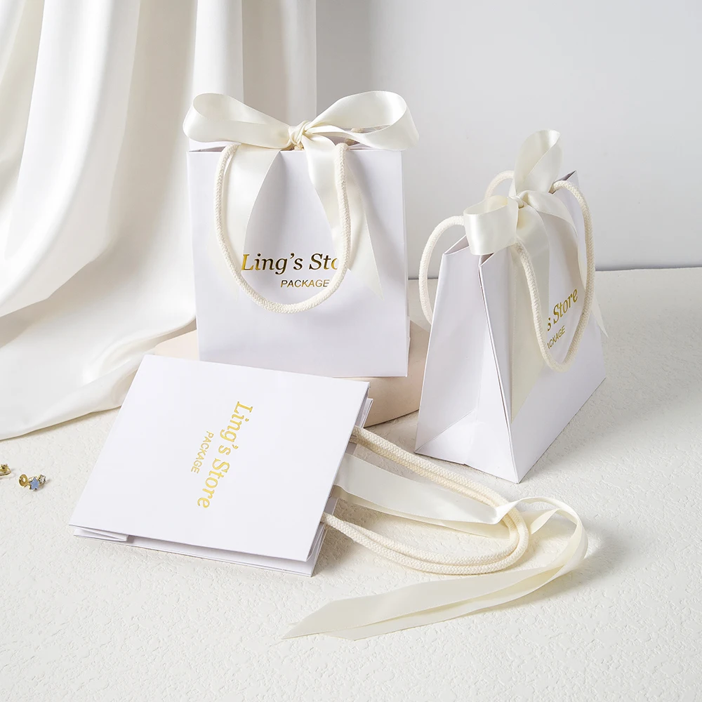 Персонализированный логотип 15,5x13,5x7,5 см, белая ювелирная бумажная сумка с ручкой, косметические свадебные сувениры, подарочная упаковка, бутик-органайзер для часов
Персонализированный логотип 15,5x13,5x7,5 см, белая ювелирная бумажная сумка с ручкой, косметические свадебные сувениры, подарочная упаковка, бутик-органайзер для часов