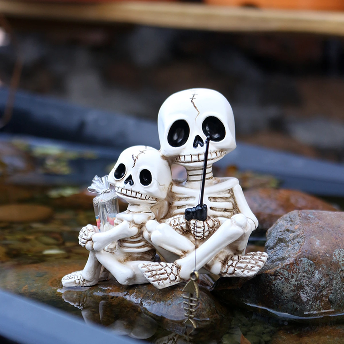 A Decorative Statue of a Father And Son Skeleton Fishing by an Outdoor Pond, Perfect for Spring Garden Decor. This Fishing Skele
A Decorative Statue of a Father And Son Skeleton Fishing by an Outdoor Pond, Perfect for Spring Garden Decor. This Fishing Skele