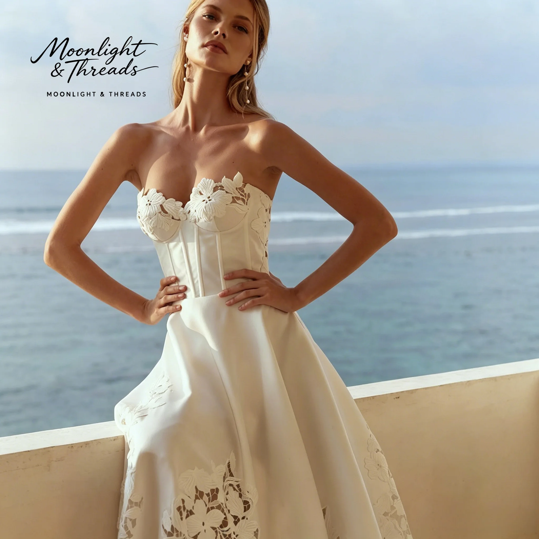 Minimalist ivory satin strapless floor-length formal wedding gown featuring a boned bodice and cutout skirt detail
Minimalist ivory satin strapless floor-length formal wedding gown featuring a boned bodice and cutout skirt detail
