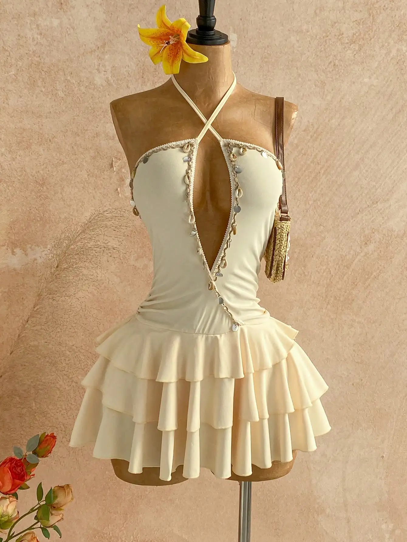 Cream Backless Halter Mini Dress with Shell Tassels and Tiered Ruffle Skirt
Cream Backless Halter Mini Dress with Shell Tassels and Tiered Ruffle Skirt