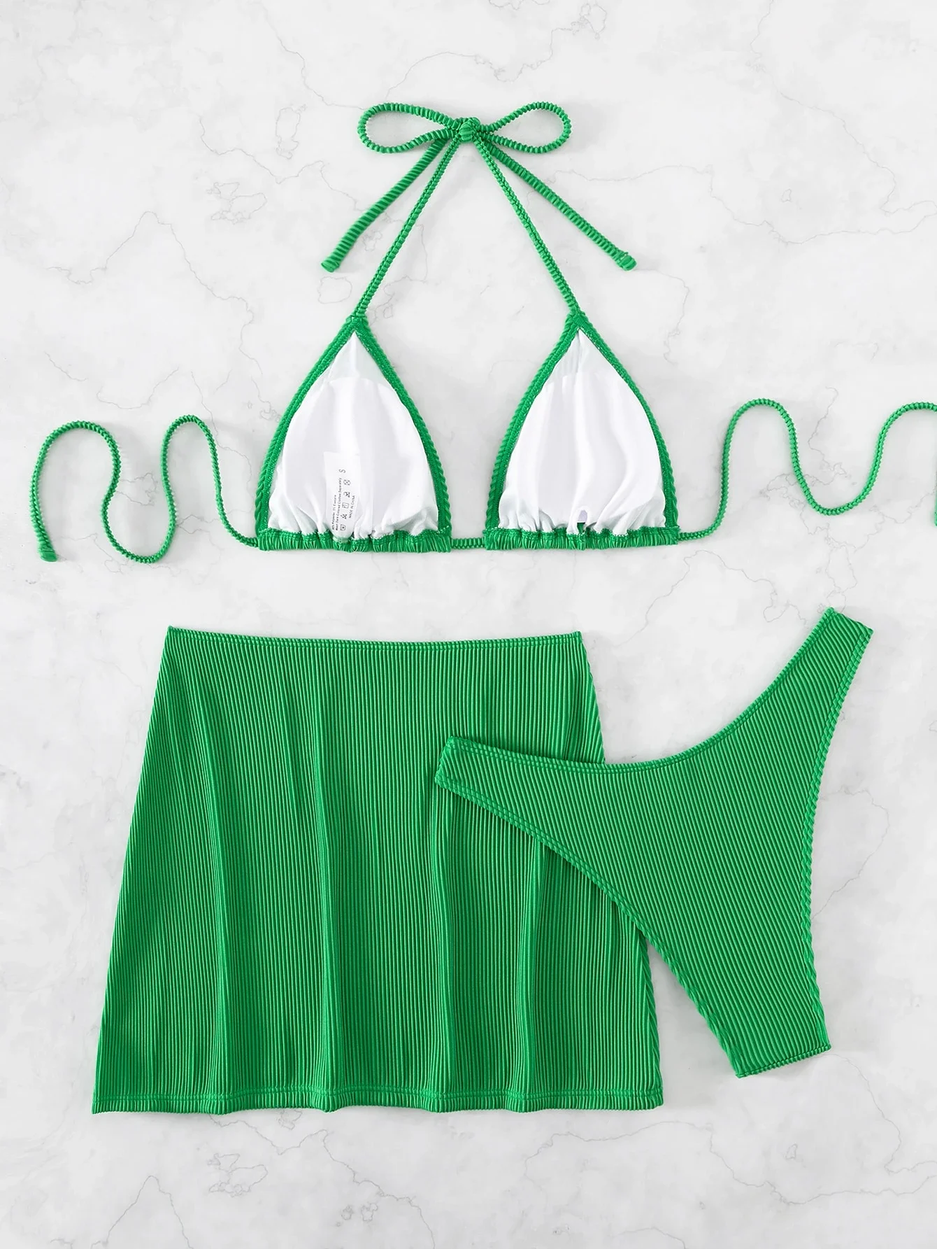 Green Ribbed 3-Piece Swimwear Set: Halter Triangle Top, High-Cut Bottom, And Matching Beach Skirt
Green Ribbed 3-Piece Swimwear Set: Halter Triangle Top, High-Cut Bottom, And Matching Beach Skirt