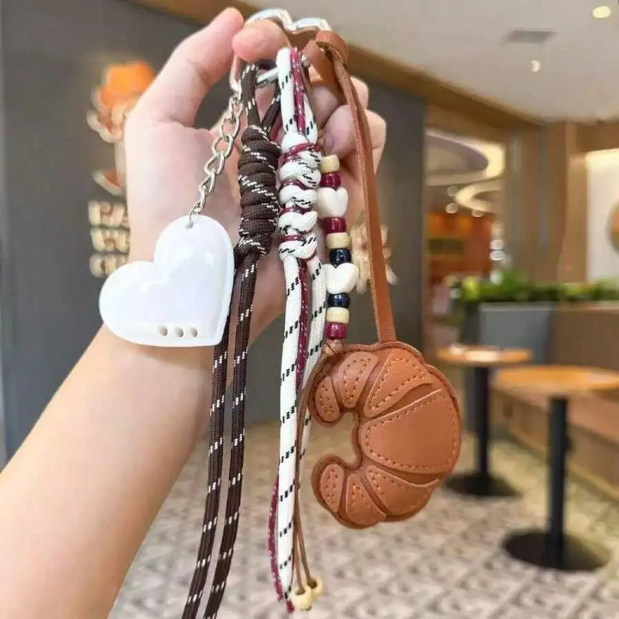 Brown Leather Croissant Keychain With Heart Charm Rope Bag Accessory For Women
Brown Leather Croissant Keychain With Heart Charm Rope Bag Accessory For Women