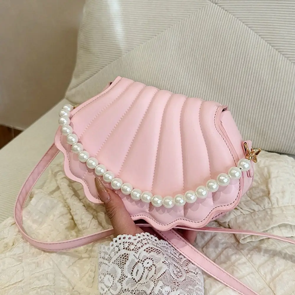 Stylish Cute Shell Shoulder Bag Minimalist with Pearls Design Pearl Decorated Handbag PU Leather Crossbody Bag for Women Girls
Stylish Cute Shell Shoulder Bag Minimalist with Pearls Design Pearl Decorated Handbag PU Leather Crossbody Bag for Women Girls