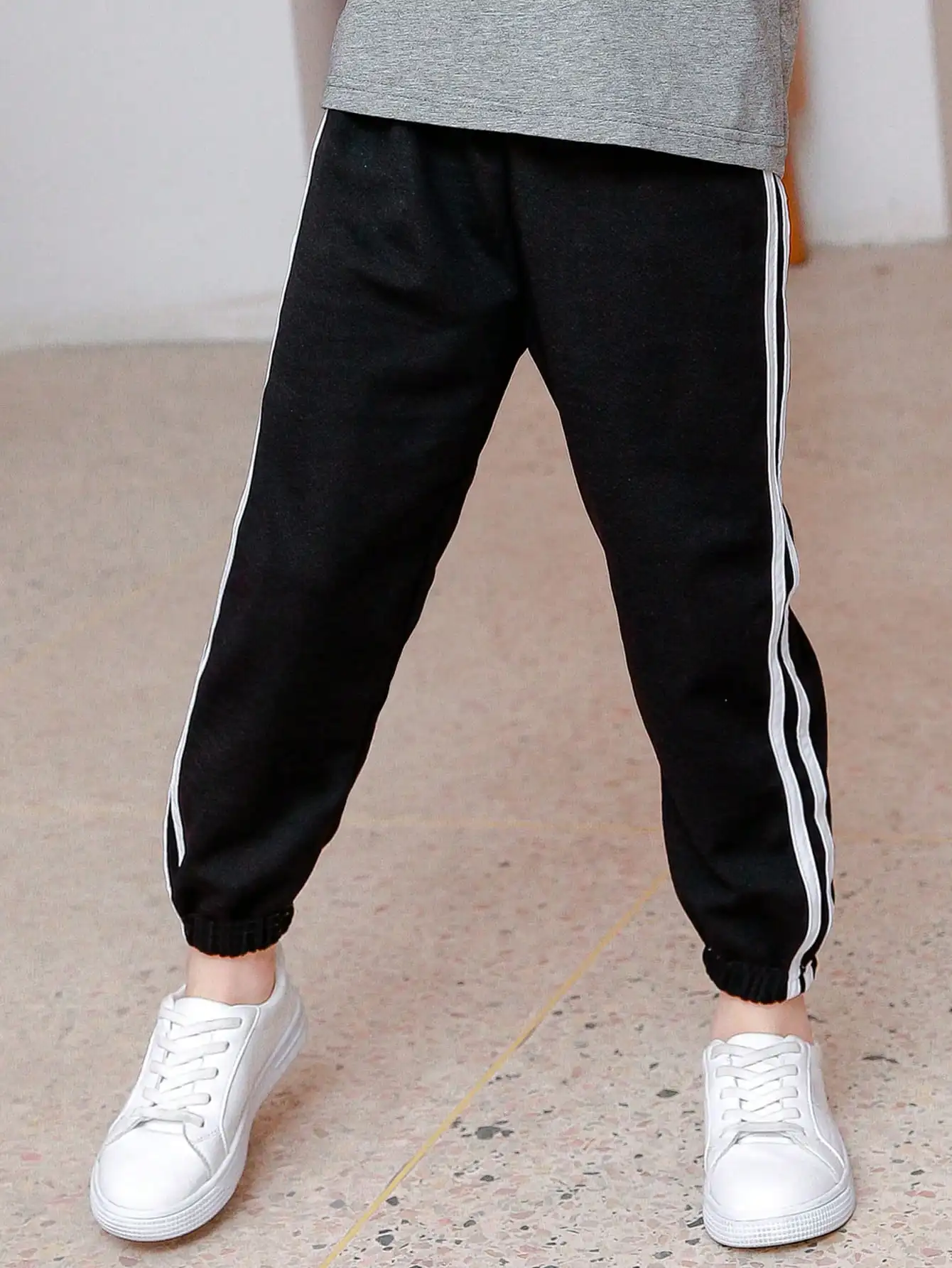 Black Kids Jogger Pants with White Side Stripes, Loose Fit, Elastic Cuffs
Black Kids Jogger Pants with White Side Stripes, Loose Fit, Elastic Cuffs