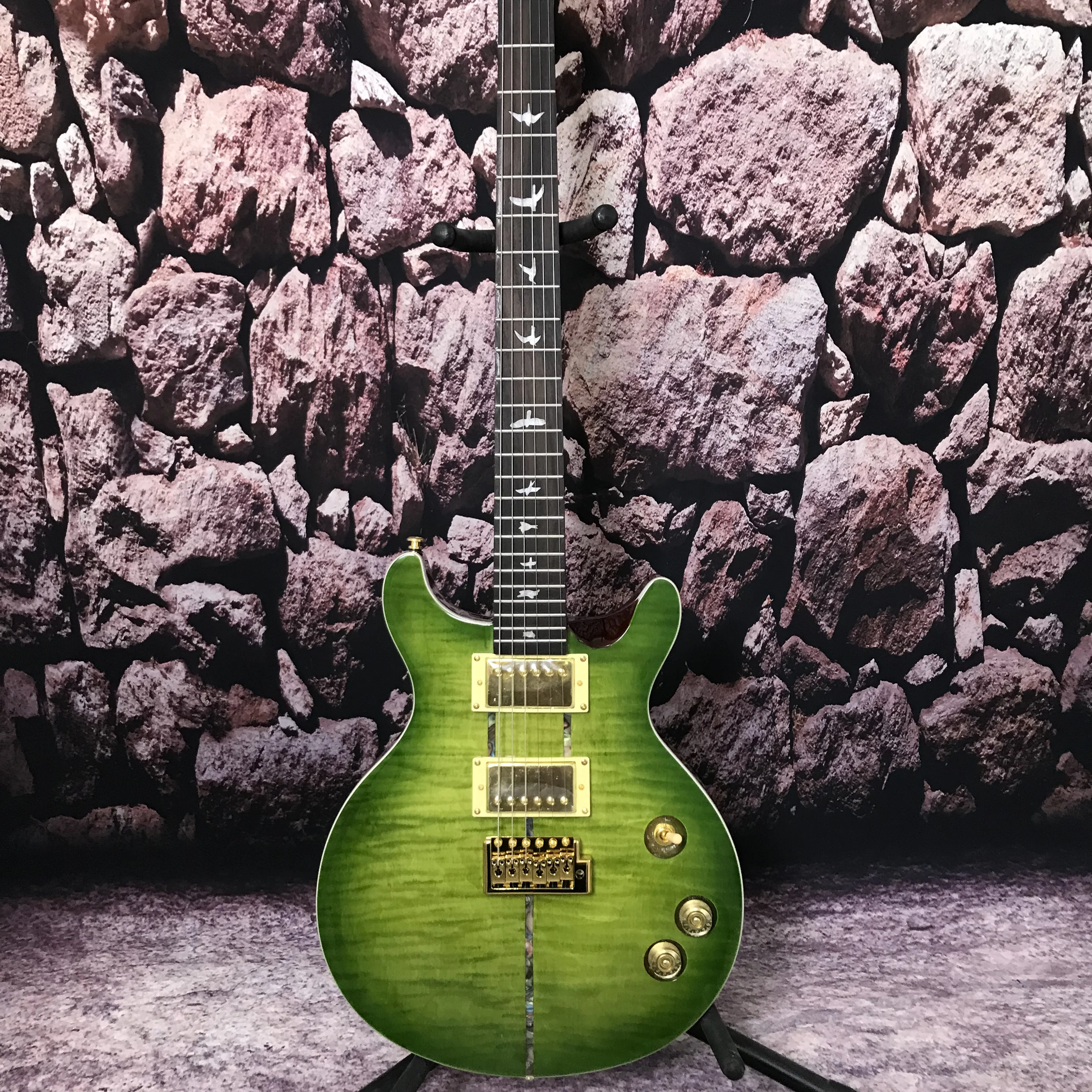 Factory custom Electric guitar green color flame maple top gold hardware bird inlays in stock
Factory custom Electric guitar green color flame maple top gold hardware bird inlays in stock